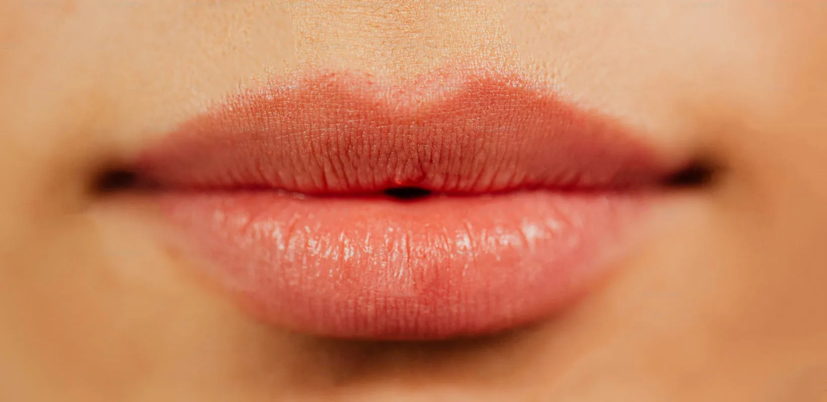 Natural lip blush treatment result — wide crop showing soft petal colour
